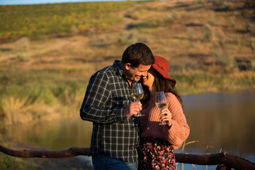 Young wife whispering something funny to her husband ear