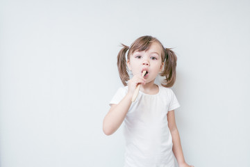 child girl brushes her teeth with a bamboo toothbrush. concept: environmental care, zero waste, ecology