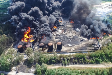 Oil storage fire. The tank farm is burning, black smoke is combu