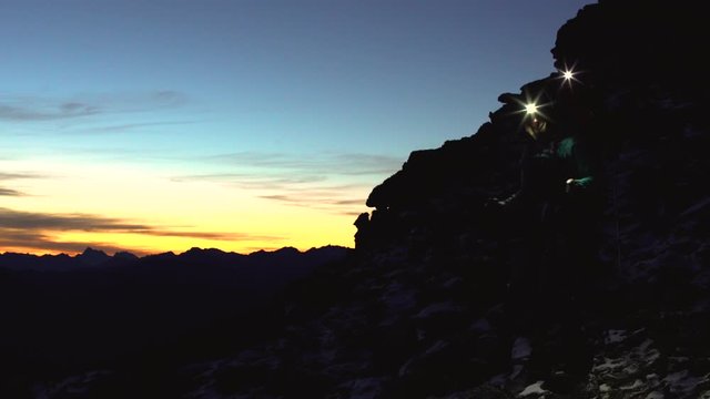 Silhouette couple with headlamp hiking sunrise The Remarkables