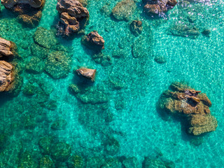 Obraz premium Aerial view of Tropea beach, crystal clear water and rocks that appear on the beach. Calabria, Italy. Swimmers, bathers floating on the water. Coastline of Calabria