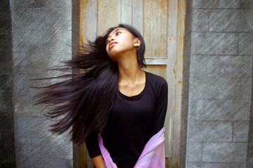 Fototapeta premium Young Asian woman flicking long hair
