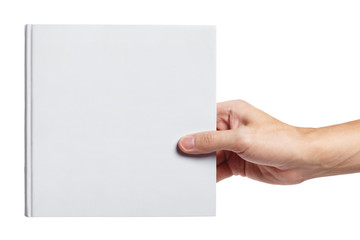 Hand holding a blank hard cover square book, isolated on white background