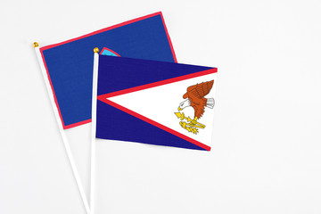 American Samoa and Guam stick flags on white background. High quality fabric, miniature national...