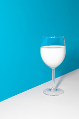 Glass of milk in blue and white background