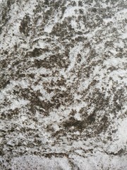 Dark gray and light gray marble pattern with black patches texture background.