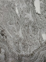 Dark gray and light gray marble pattern with black patches texture background.