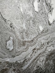 Dark gray and light gray marble pattern with black patches texture background.