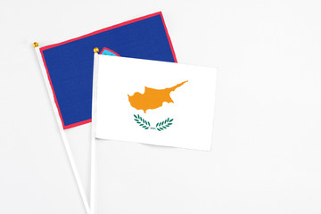 Cyprus and Guam stick flags on white background. High quality fabric, miniature national flag. Peaceful global concept.White floor for copy space.