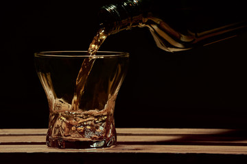 Whiskey is poured into a glass