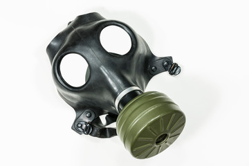 Old army surplus gas mask with white background.  