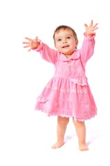 Funny surprised little girl in pink dress plays with soap bubbles on white isolated background. Happy childhood
