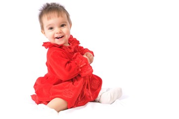 Funny surprised little girl in red Christmas dresses on white isolated background. Happy childhood