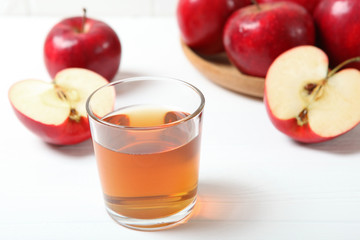 apple juice from red apples on the table.