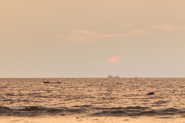 Sunset view, from the shore, of a distant Floating Production Storage and Offloading (FPSO) unit, Kribi beach
