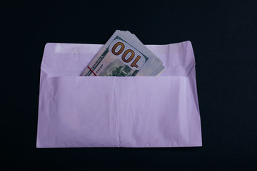 Dollar money in the envelope on black background. bonus, reward, benefits concept, bribe gift....