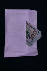 Dollar money in the envelope on black background. bonus, reward, benefits concept, bribe gift. Shadow economy, illegal salary in an envelope without taxes