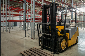 Compact forklift truck in a industrial warehouse building