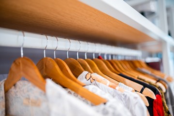 clothes hanging on a hanger in a wardrobe