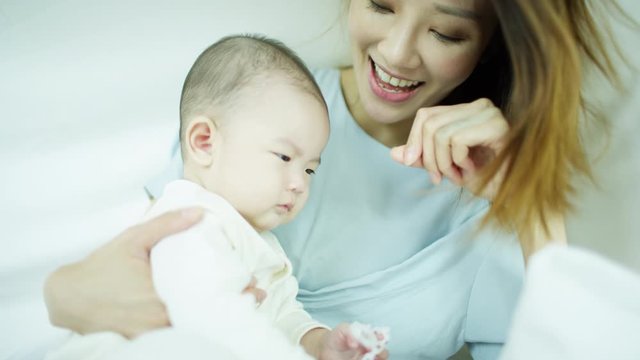 Chinese Asian mum baby relaxing enjoying time together