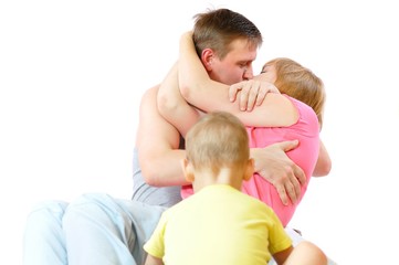 Kissing couple of caucasian parents with child. Concept lonely boy and busy adult husband and wife. Isolated on white background