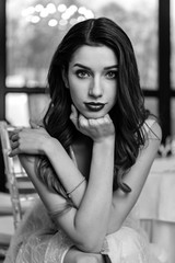 Beautiful girl bride in front of the camera, designer dress, sensual look. Black and white...