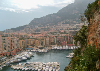 Panoramic aerial view of Monaco Port and houses on rainy cloudy day. Mediterranean coastline, France