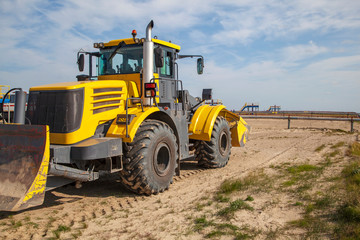 Fototapeta na wymiar wheeled tractor, multi-purpose loader, with shovel