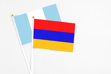 Armenia and Guatemala stick flags on white background. High quality fabric, miniature national flag. Peaceful global concept.White floor for copy space.