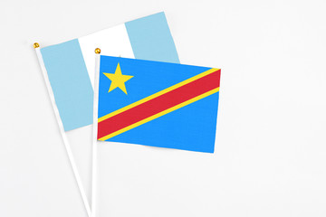 Congo and Guatemala stick flags on white background. High quality fabric, miniature national flag. Peaceful global concept.White floor for copy space.