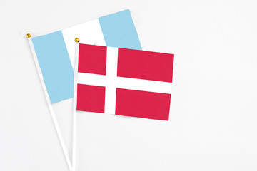 Denmark and Guatemala stick flags on white background. High quality fabric, miniature national flag. Peaceful global concept.White floor for copy space.