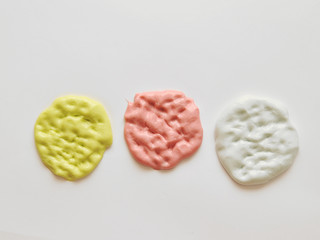 Child hands with home-made slime.  Baby makes a home made slime with glue and glitters on background.