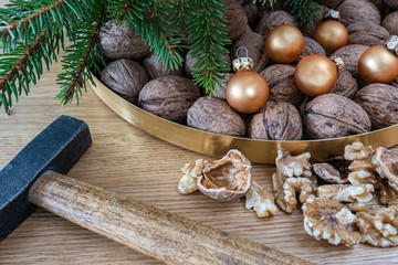 Merry Christmas decoration  with walnuts on a natural oak wooden background. A natural perspective composition in brown and gold  colors. 