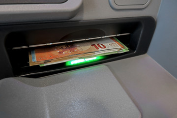 Withdraw money at the ATM at the bank