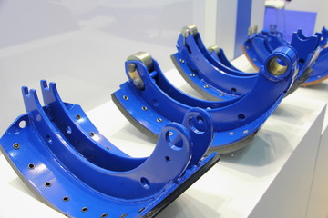 New blue truck brake pads for drum brakes close up on white background