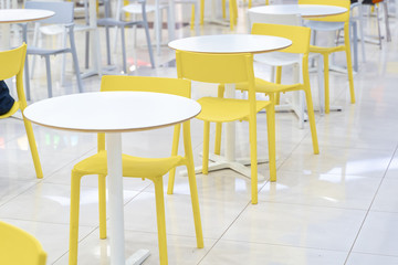 Food court in the mall. Empty tables and chairs