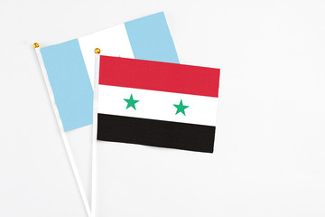 Syria and Guatemala stick flags on white background. High quality fabric, miniature national flag....