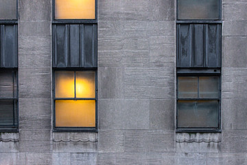 warmly lit window on urban building