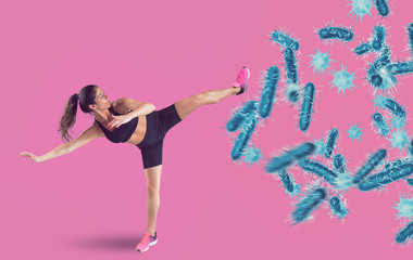 Aggressive woman fights with a kick against bacteria and disease - obrazy, fototapety, plakaty