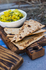Cooked vegetables. Potato with spinach. Indian sabji with chapati, naan, paratha. 
