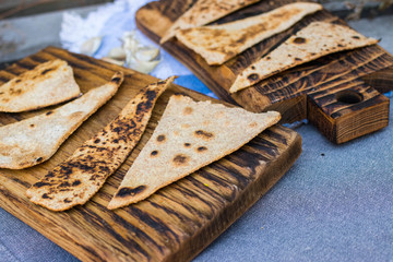 Chapati - Indian traditional tandoori naan bread on wooden board.