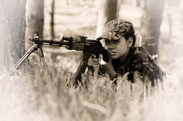 Young girl with a rifle. Security, beautiful.