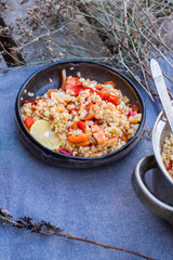 Cooked bulgur wheat mediterranean salad with fresh vegetables and lemon. Tabbouleh - Turkish, Arabian, Levantine traditional pilaf food.