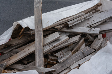 construction garbage. wood residues with nails thrown into a pile on film.