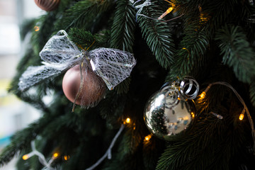 New Year tree with different toys and balls. Christmas lights and toys.