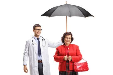 Doctor holding an umbrella over a senior woman