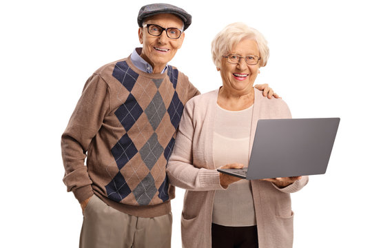 Happy elderly man and woman with a laptop