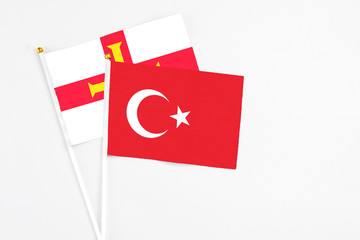 Turkey and Guernsey stick flags on white background. High quality fabric, miniature national flag....