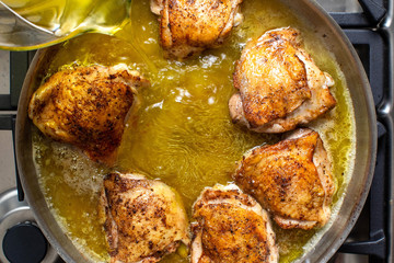 Overhead view of pan searing chicken breasts