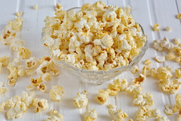 Salt popcorn on the wooden table, selective focus. Horizontal. Copy space.